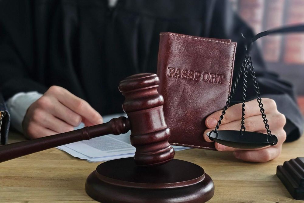 a judge holding a book and a gaven on a table