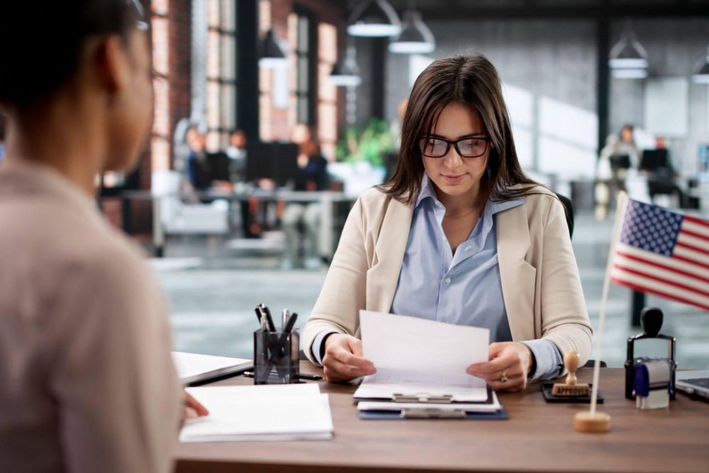 a woman sitting at a desk in an office