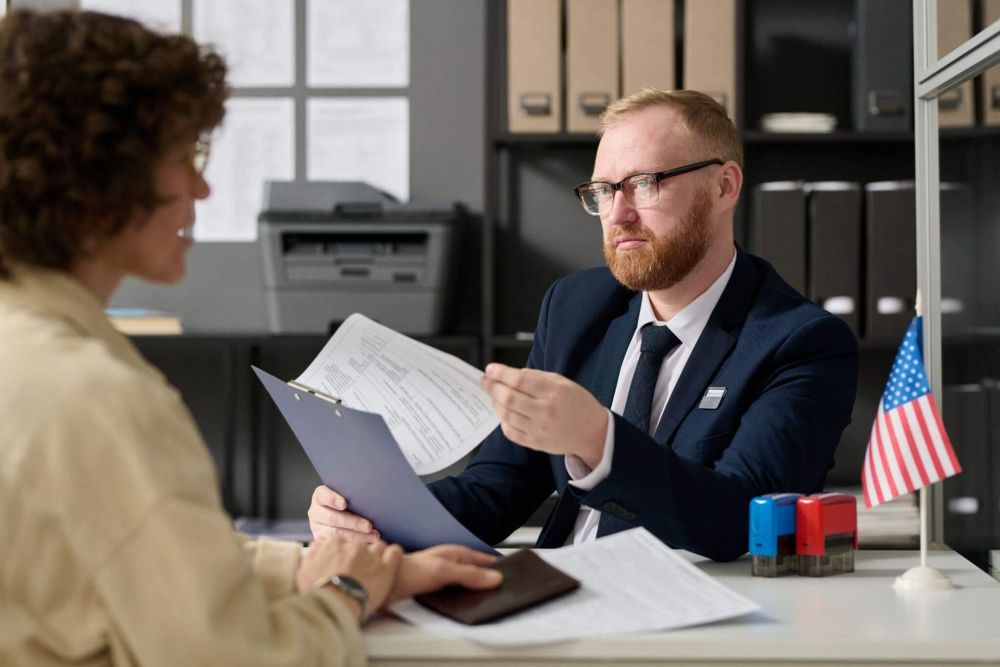 a man and a woman sitting at a desk in an office