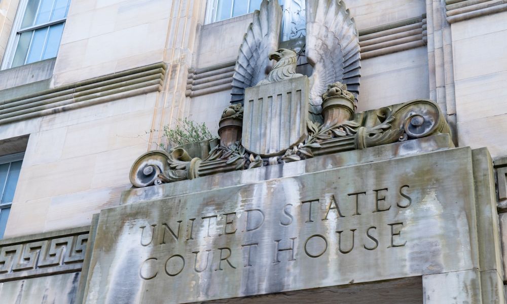 Detail of United States Courthouse facade with eagle sculpture and ornate architectural features.