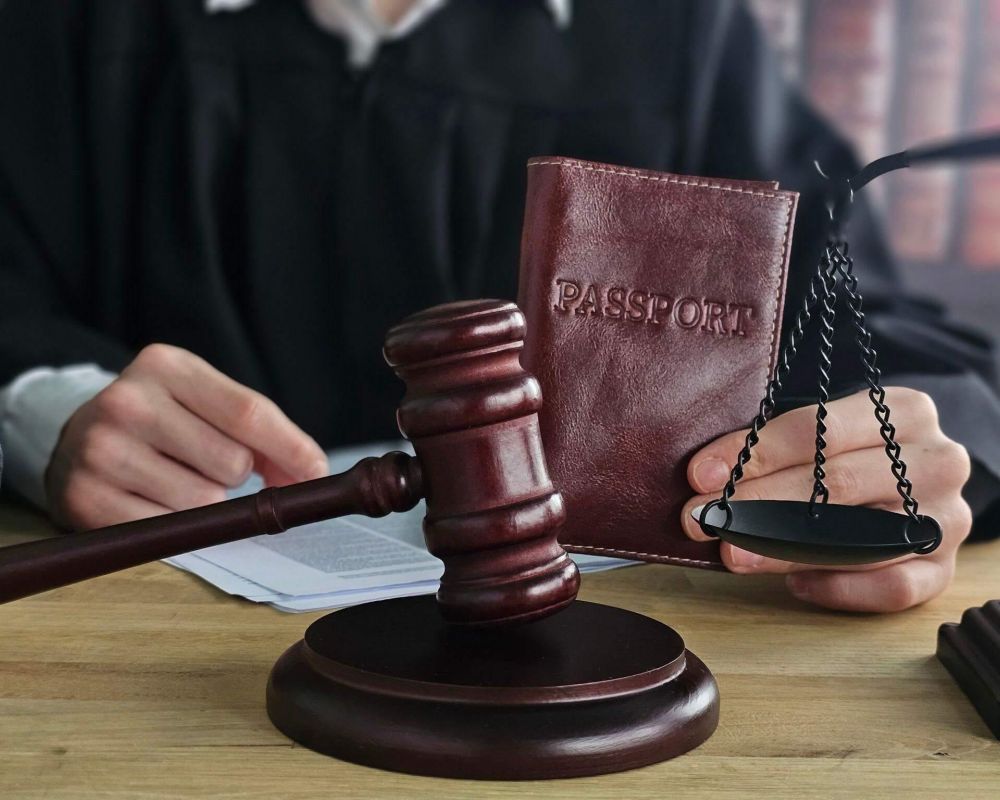 a judge holding a book and a gaven on a table