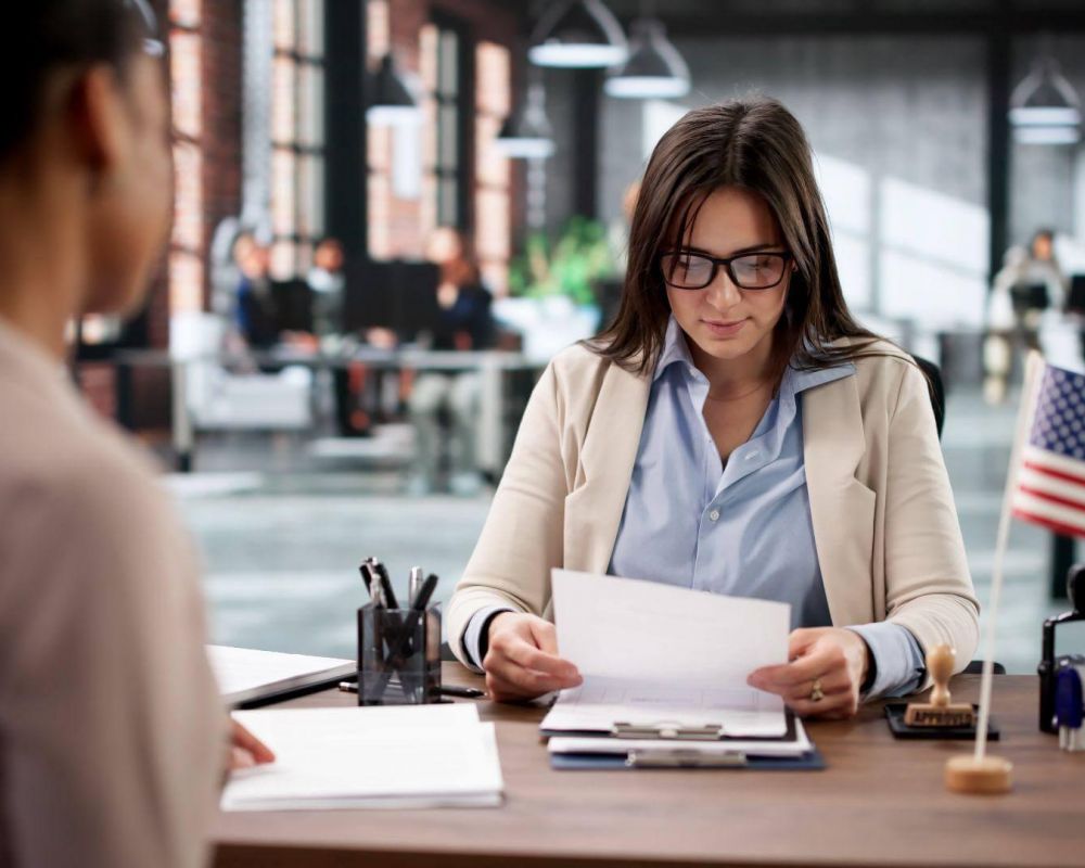 a woman sitting at a desk in an office