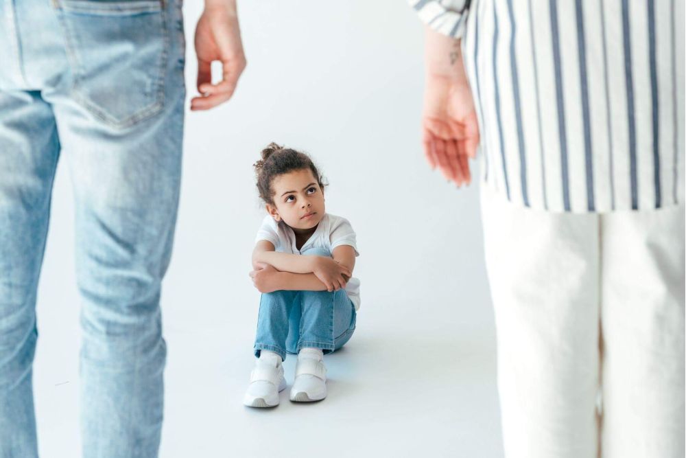 Man and little girl sitting on the ground