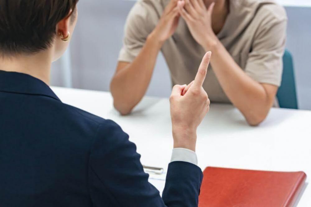 Man and woman discussing deportation case with a lawyer