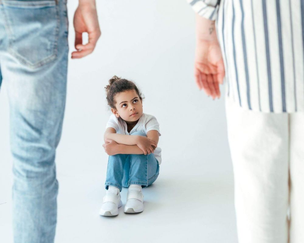 Man and little girl sitting on the ground