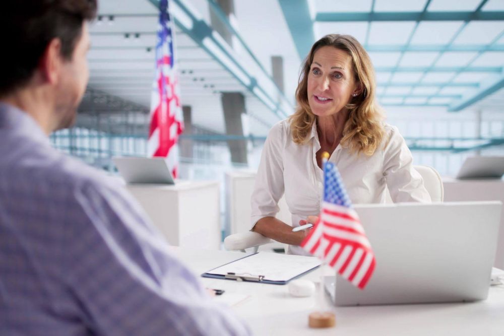 Woman at desk with American flag for