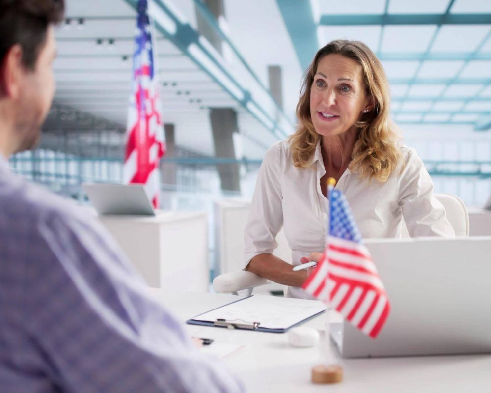 Woman at desk with American flag for