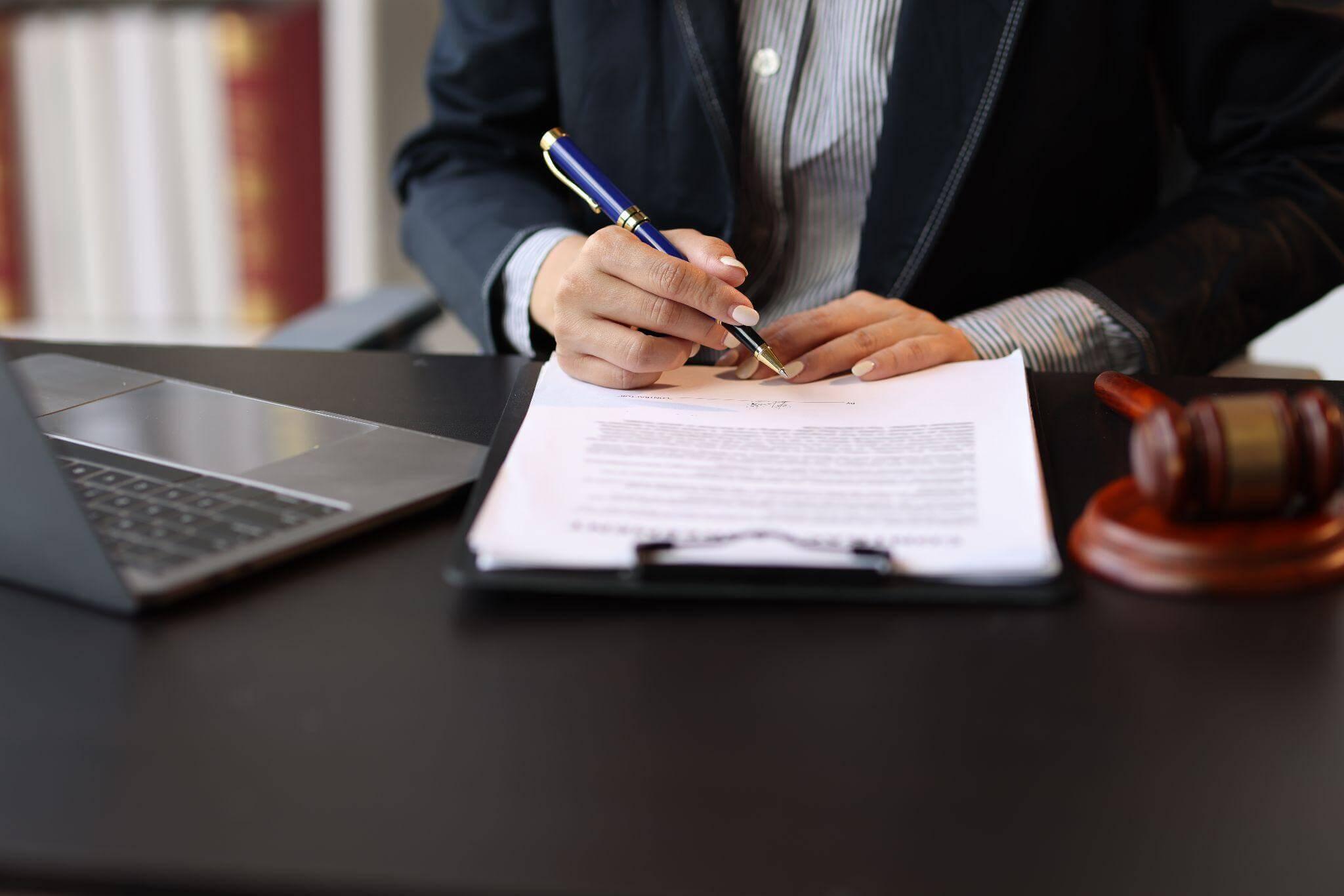 Man writing at a desk.